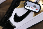 Close-up of the white and black side panel, glossy black side branding, black laces and a visible branded hangtag.