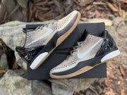 Pair of Nike Kobe 6 sneakers displayed on a black box, showing the side profile and patterned upper.
