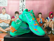 Angled view showing the green upper, patterned laces, Swoosh, and blue-orange graphic panels.