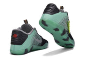 Mint green and black basketball shoes showing heel and outsole details
