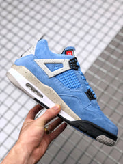 Side view of the blue Air Jordan 4 sneaker showing the mesh panel, speckled side support, and visible midsole window.