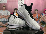 Angled view of the white and black Nike basketball sneakers, showing the textured upper, laces, and high-top construction.