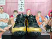 Front view of the pair showing black laces and tongues, gold toe panels, and rounded black outsoles.