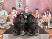 Rear view of Nike GT Cut shoes with red heel branding and accents