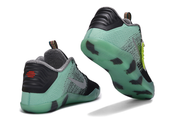Mint green, black and gray Kobe 11 sneakers shown from the heel and translucent outsole.