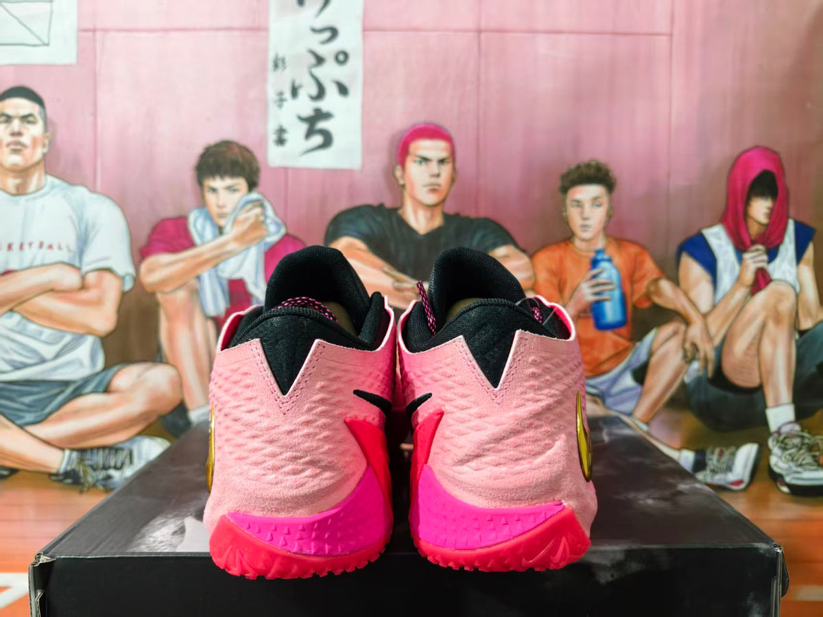Rear view of pink and black Nike basketball shoes with bright pink outsoles