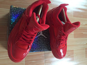 Top view of a red high-top sneaker pair showing matching laces, tongues, and mesh toe panels.