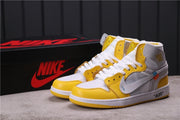 Pair of white, yellow, and grey high-top Jordan sneakers shown with a black branded shoe box.