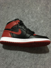 Side profile showing the high-top silhouette, red Swoosh, black panels, white midsole, and red outsole.