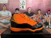 Side profile showing the orange upper, glossy black overlays, Jordan branding, and black-and-orange outsole.