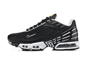 Side view of a black and white Nike Air Max Plus III sneaker