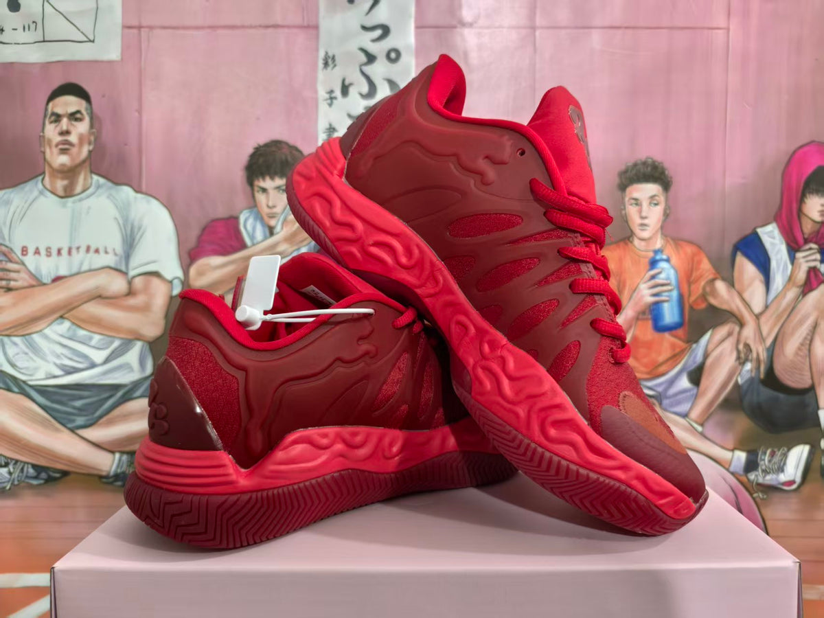 Red basketball-style sneakers shown from the side and sole, with sculpted outsole details.