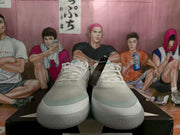 Front view showing the pair's white laces, textured uppers, and rounded rubber toe areas.