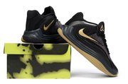 Black and gold Nike Giannis Immortality 7 shoes beside a display box