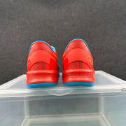 Rear view of the red basketball sneakers showing blue outsole edges, blue collar lining, and heel details.