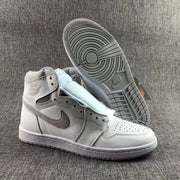 High-top sneaker beside its outsole, showing the tread pattern and grey accents.