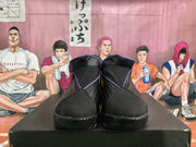 Front view showing the padded tongues, black uppers, purple trim and textured toe outsoles.
