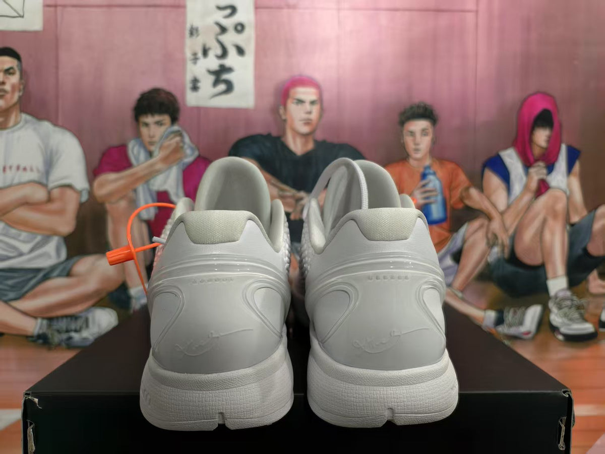 Rear view of white Nike basketball sneakers showing the padded collars, heel panels and sculpted midsoles.