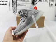 Angled side view of the gray lace-up sneaker with translucent outsole.