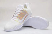 Angled view of a white lace-up sneaker with multicolor side panel beside its outsole.