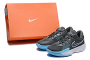 Dark grey and light blue Nike basketball shoes pictured beside an orange Nike shoe box.