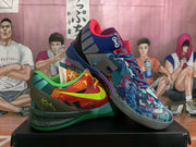 Angled view of the mismatched pair, showing the red and green shoe beside a blue, purple, and red patterned shoe.