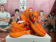 Angled view showing the orange textured upper, multicolor side-panel graphics, and sculpted sole.