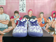 Front view showing the patterned white uppers, purple laces, and rounded toe boxes.