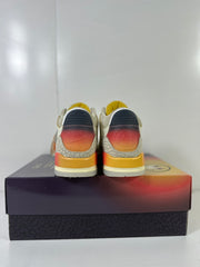 Rear view showing the sunset-gradient heel panels and elephant-print detailing.
