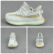 Composite product view showing side, front, and rear angles of the pale gray and tan children's sneakers.