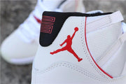 Side close-up of the red Jordan logo, white upper, and red trim.