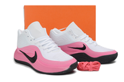 White and pink Nike basketball sneakers displayed in front of an orange shoe box.