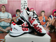 Angled view of the pair showing the illustrated upper, black outsole, red accents, and black laces.