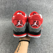 Rear view of the pair with red heel panels and elephant-print overlays.