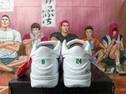 Rear view of white basketball shoes with green 8 and 24 heel numbers and signature-style graphics.