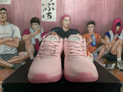 Front view of the pair showing pink laces, padded collars, and rounded toe boxes.