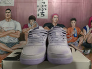 Front view of the purple Nike sneakers showing tonal laces, perforated toe panels, and flat rubber outsoles.