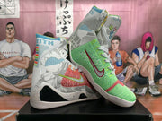 Angled view of the mismatched pair displaying the green and coral-red uppers, patterned gray panels, swoosh accents, and white soles.