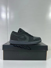Side profile of a dark grey and black low-top sneaker on a shoebox