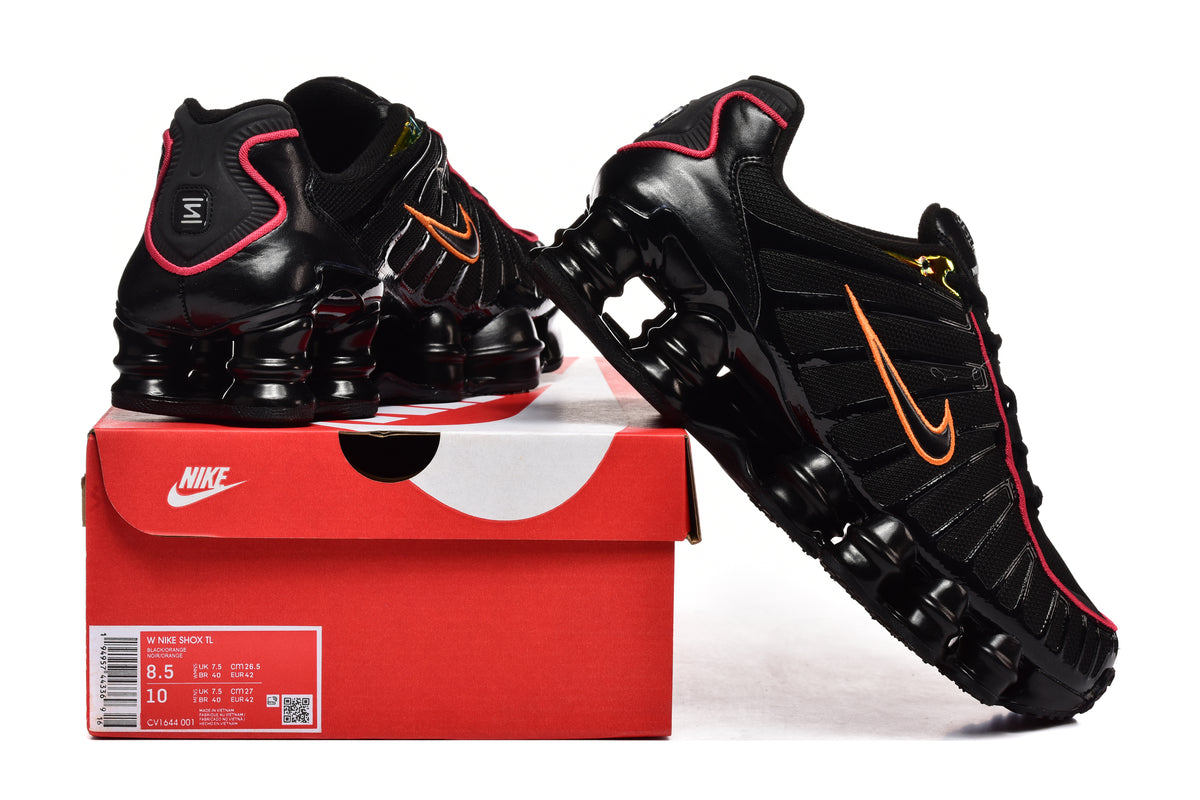 Black Nike Shox TL sneakers with orange Swooshes and pink trim displayed with a shoe box