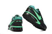 Rear and outsole views of a black and mint-green Nike Air Max sneaker.