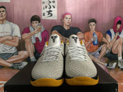 Front view showing Kobe tongue logos, white laces, and yellow outsoles
