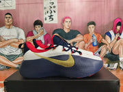 Side view showing the gold Swoosh and navy outsole on a Nike basketball shoe