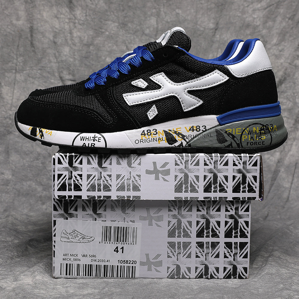 Black low-top sneaker with a white side emblem, blue laces and accents, shown on a patterned shoe box labeled size 41.