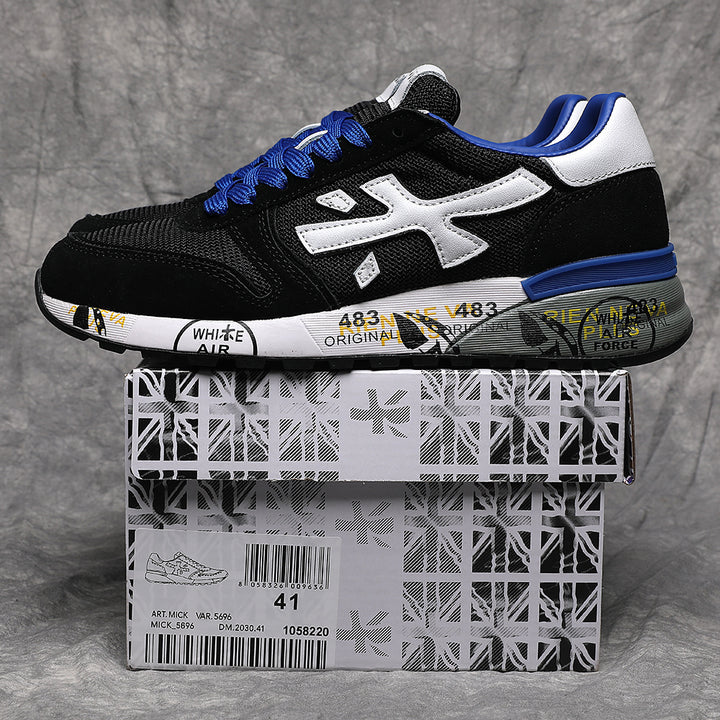 Black low-top sneaker with a white side emblem, blue laces and accents, shown on a patterned shoe box labeled size 41.