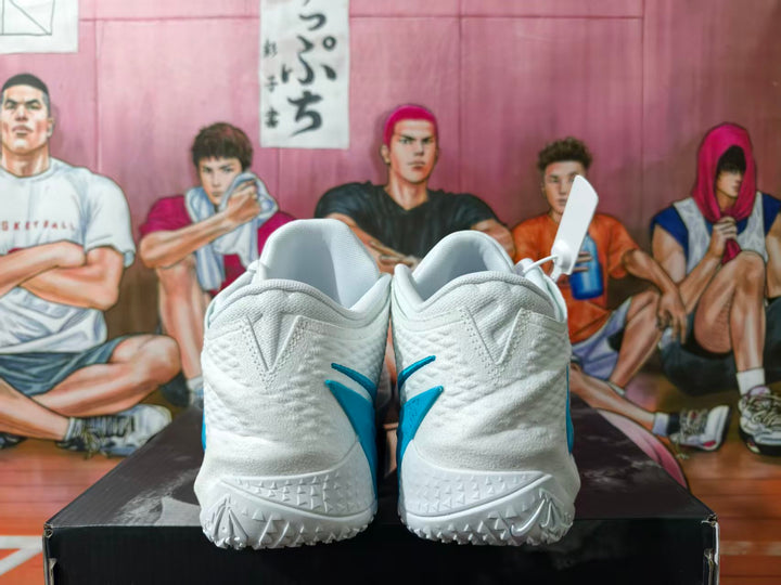 Rear view of white Nike basketball shoes with blue heel details.
