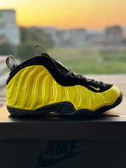 Yellow and black high-top Foamposite-style sneaker with a black outsole.