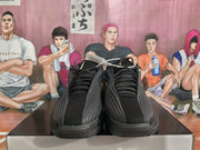 Front view of black Nike basketball sneakers with layered forefoot panels and tonal laces.