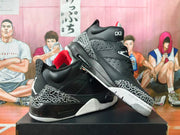Angled side view of black high-top sneakers with elephant-print overlays, red lining, and white outsole.