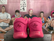 Rear view of the pink shoes showing padded heel collars and visible A'ja branding.